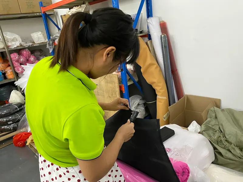 Woman inspecting fabric in workshop
