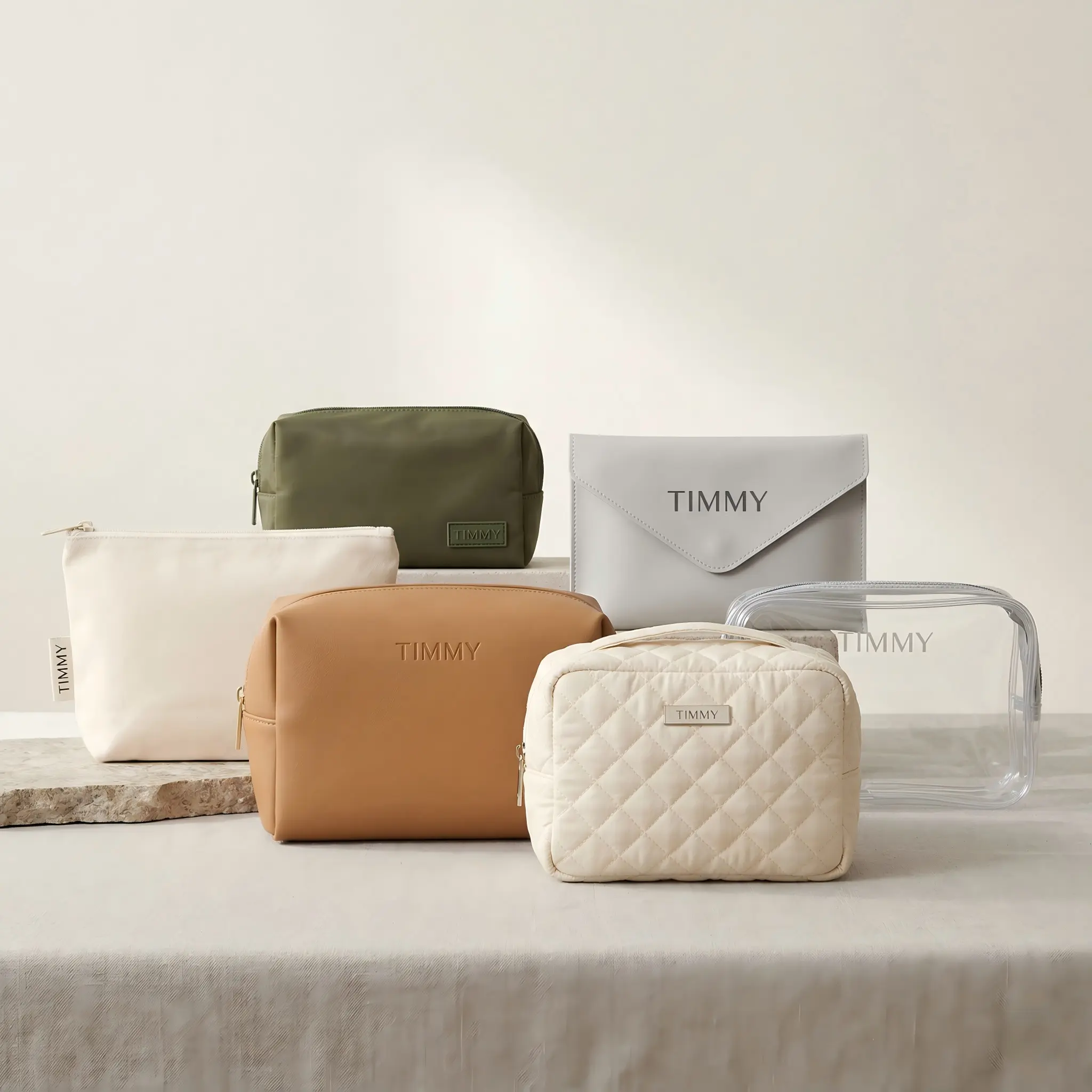 Square hero image showing four TIMMY custom cosmetic bags in different materials with different logo applications